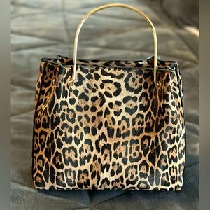 Leopard print satchel purse with gold hardware. Lightweight and spacious.
